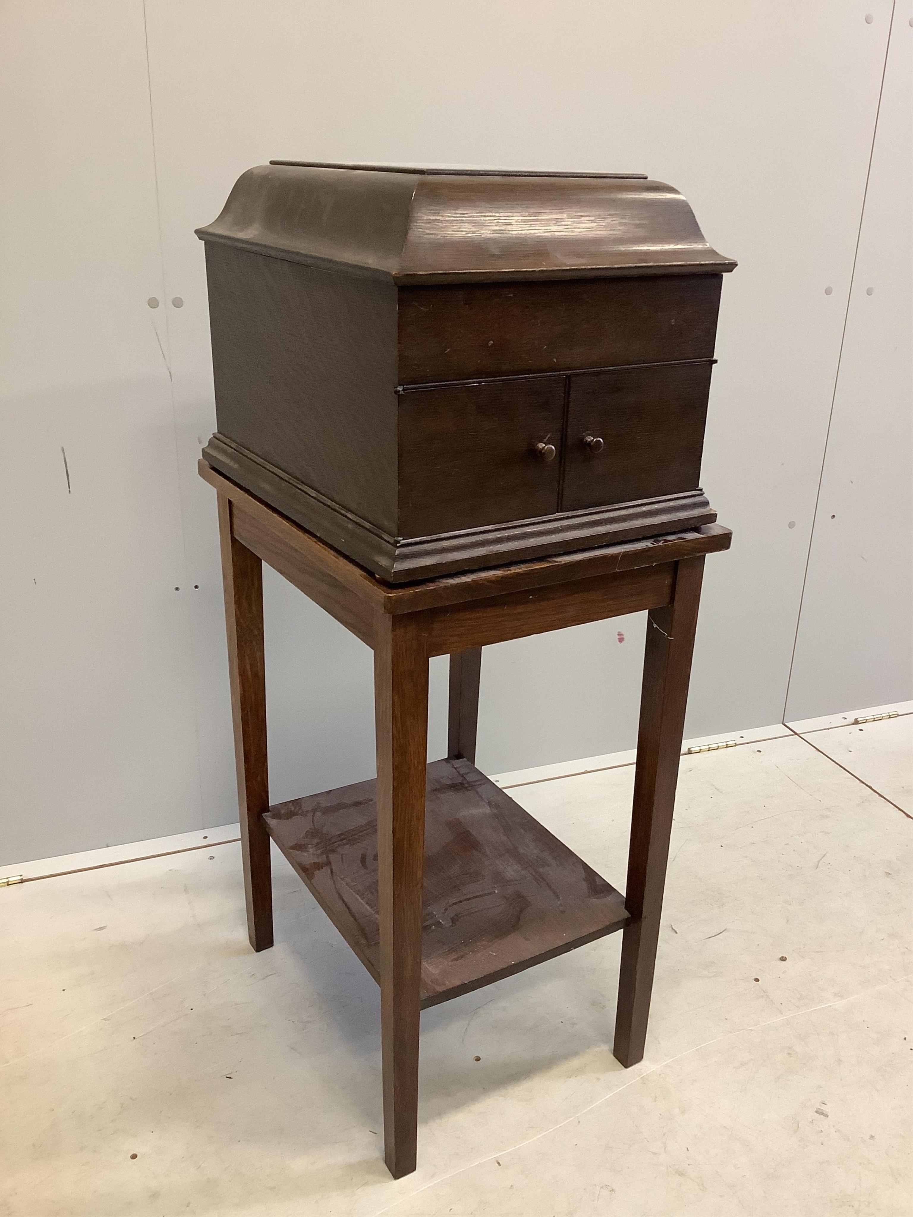 An HMV oak cased table-top gramophone on associated stand together with a collection of 78rpm records. Condition - fair